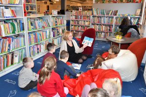Na zdjęciu powadzaca zajęcia bibliotekarka z dziećmi.